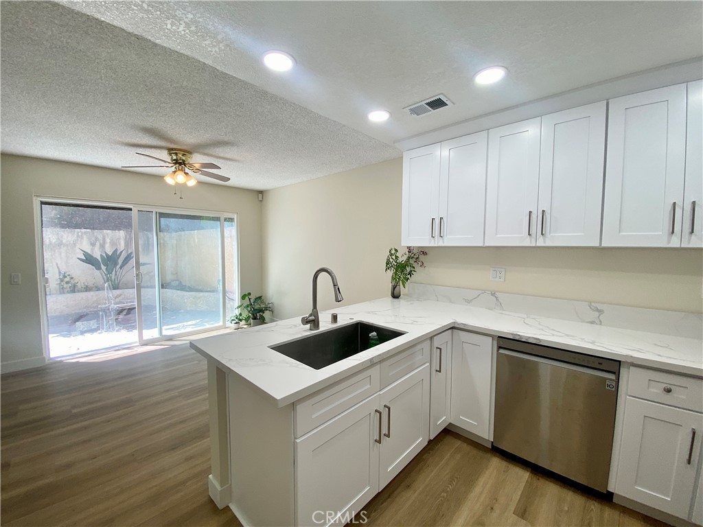 3 Cll Del Rey Phillips Ranch, CA 91766 - Photo 5 of 25 a kitchen with a sink and cabinets