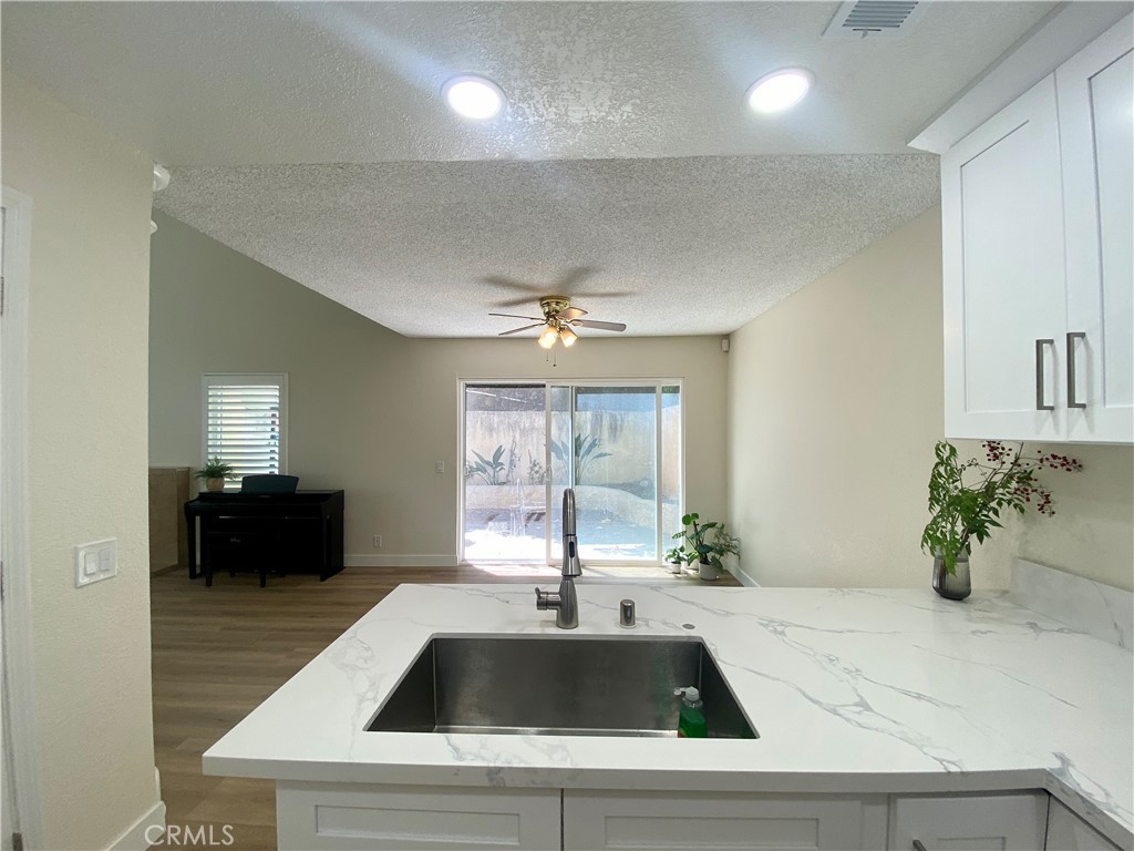 3 Cll Del Rey Phillips Ranch, CA 91766 - Photo 6 of 25 a kitchen with a sink and a refrigerator