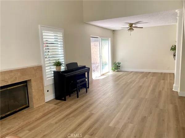 a view of a livingroom with a fireplace and a window