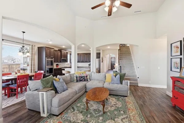 a living room with furniture and wooden floor