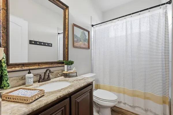 a living room with furniture a bookshelf and a large window