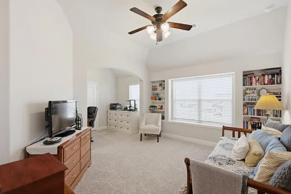 a bedroom with furniture and a large mirror