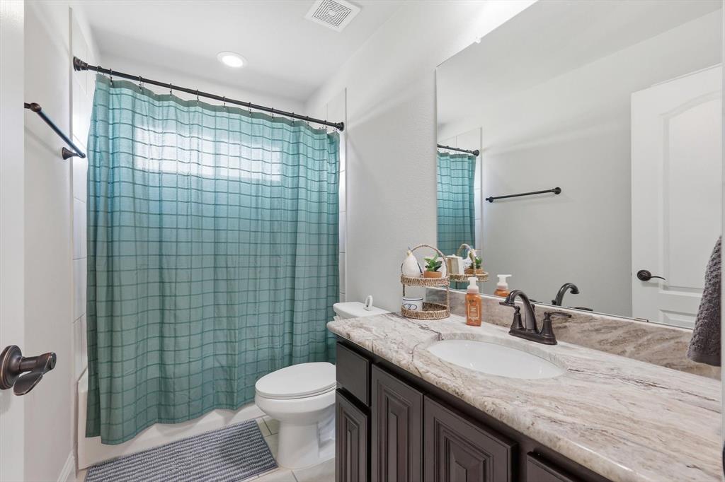 3120 Jessup Circle Blue Ridge, TX 75424 - Photo 29 of 35 a bathroom with a granite countertop sink a toilet and shower