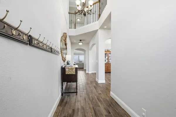 a view of entryway and hall with wooden floor