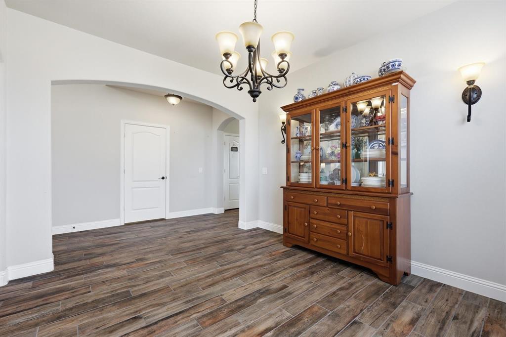 3120 Jessup Circle Blue Ridge, TX 75424 - Photo 8 of 35 a view of an empty room with chandelier and wooden floor