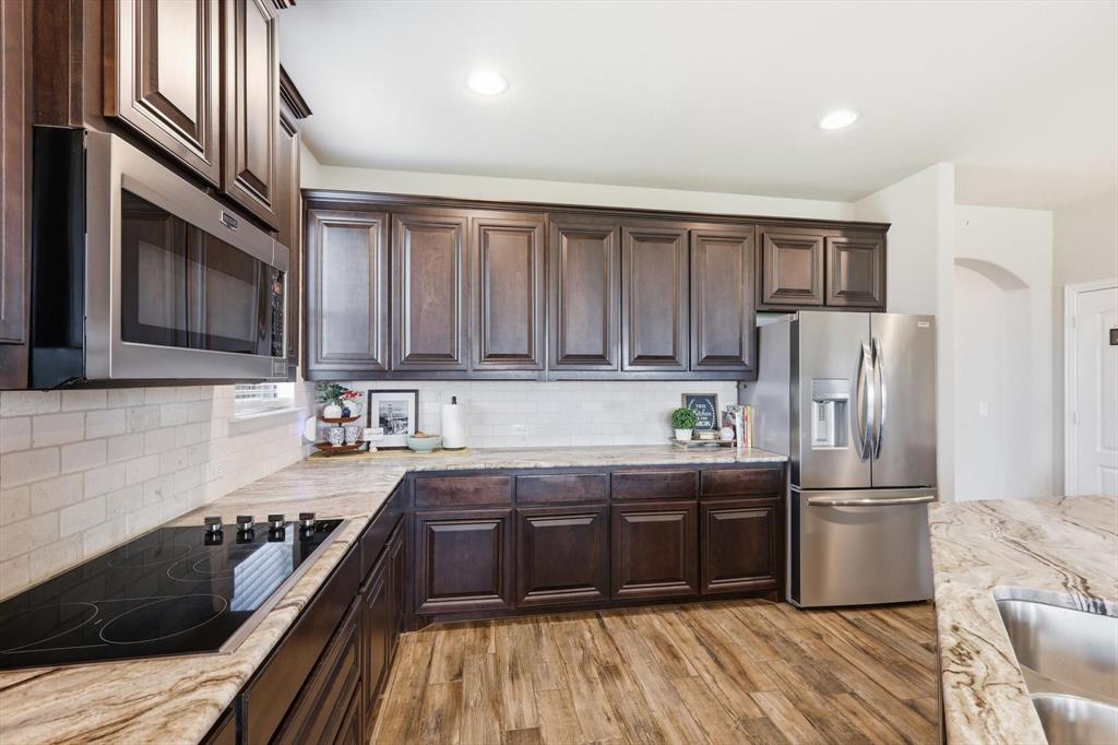 3120 Jessup Circle Blue Ridge, TX 75424 - Photo 10 of 35 a kitchen with granite countertop stainless steel appliances and wooden cabinets