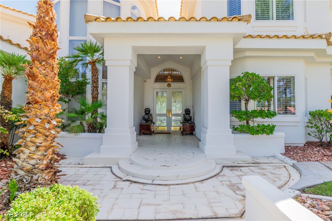 23 Cascade Creek Lane Las Vegas, NV 89113 - Photo 12 of 89 Doorway to property with stucco siding, french doors, and a tiled roof
