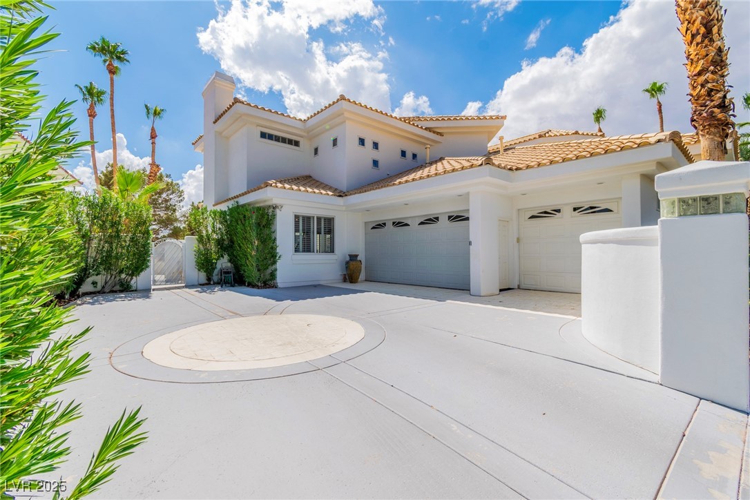 23 Cascade Creek Lane Las Vegas, NV 89113 - Photo 13 of 89 Mediterranean / spanish house with a gate, stucco siding, an attached garage, and concrete driveway