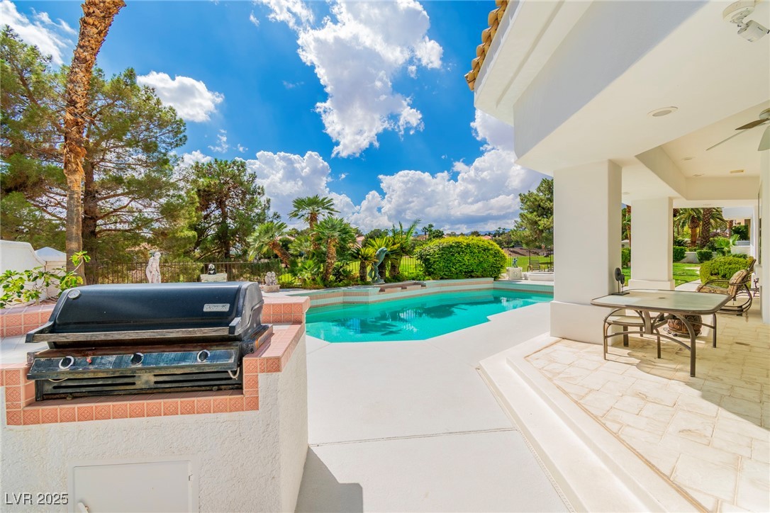 23 Cascade Creek Lane Las Vegas, NV 89113 - Photo 15 of 89 Outdoor pool featuring a patio area, exterior kitchen, and outdoor dining space