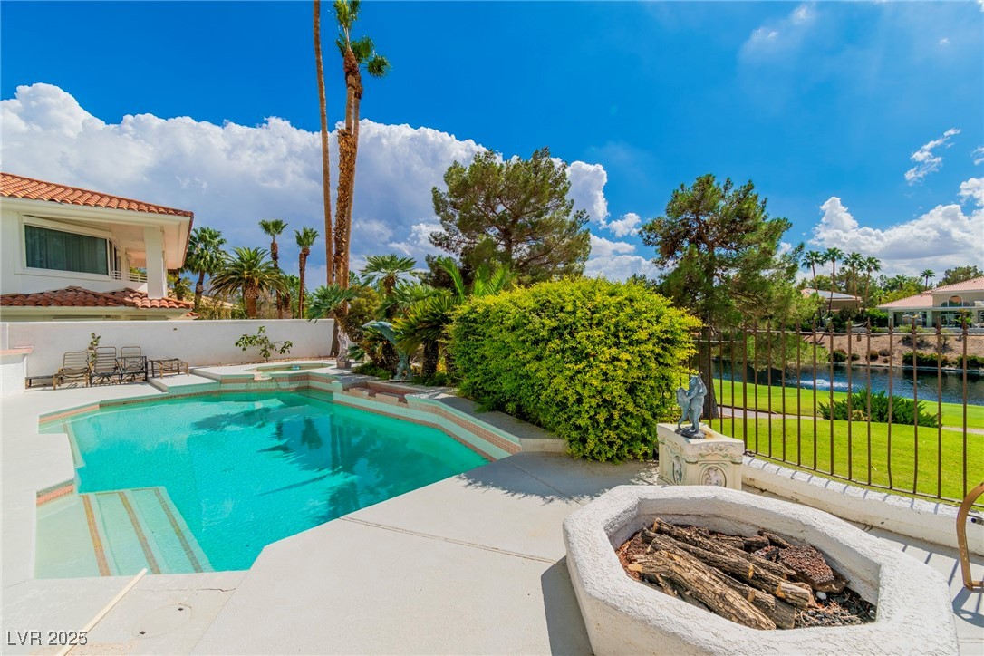23 Cascade Creek Lane Las Vegas, NV 89113 - Photo 19 of 89 View of swimming pool with a patio area, a water view, an outdoor fire pit, and a pool with connected hot tub