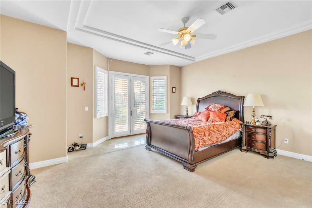 23 Cascade Creek Lane Las Vegas, NV 89113 - Photo 25 of 89 Bedroom featuring light colored carpet, french doors, access to exterior, and a ceiling fan