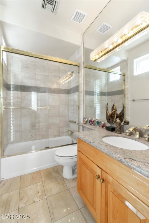 23 Cascade Creek Lane Las Vegas, NV 89113 - Photo 27 of 89 Bathroom with bath / shower combo with glass door, vanity, and light tile patterned flooring