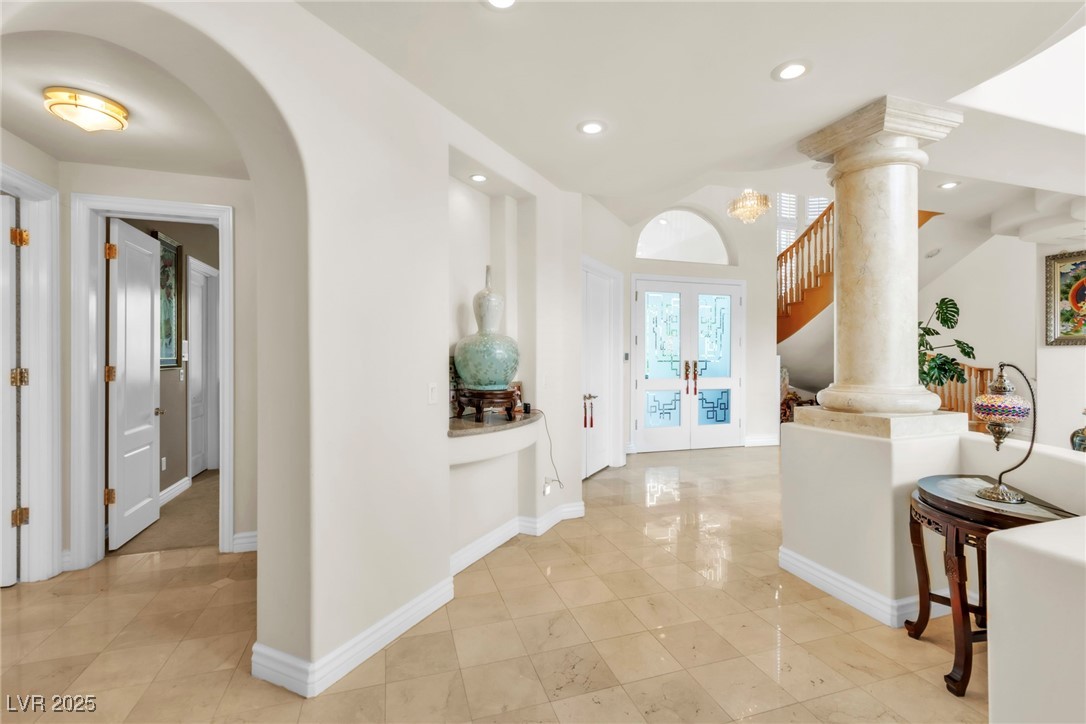 23 Cascade Creek Lane Las Vegas, NV 89113 - Photo 28 of 89 Hallway featuring french doors, recessed lighting, light tile patterned floors, and stairway
