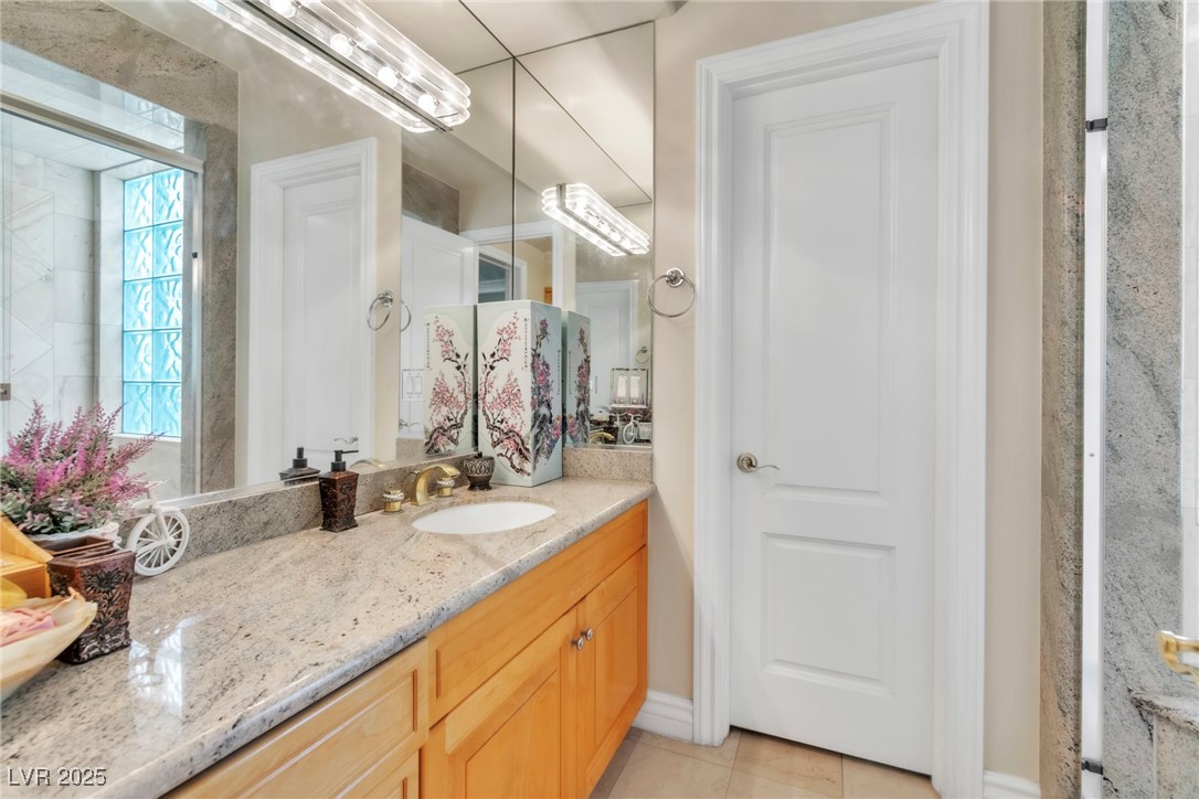 23 Cascade Creek Lane Las Vegas, NV 89113 - Photo 31 of 89 Bathroom with vanity and light tile patterned floors