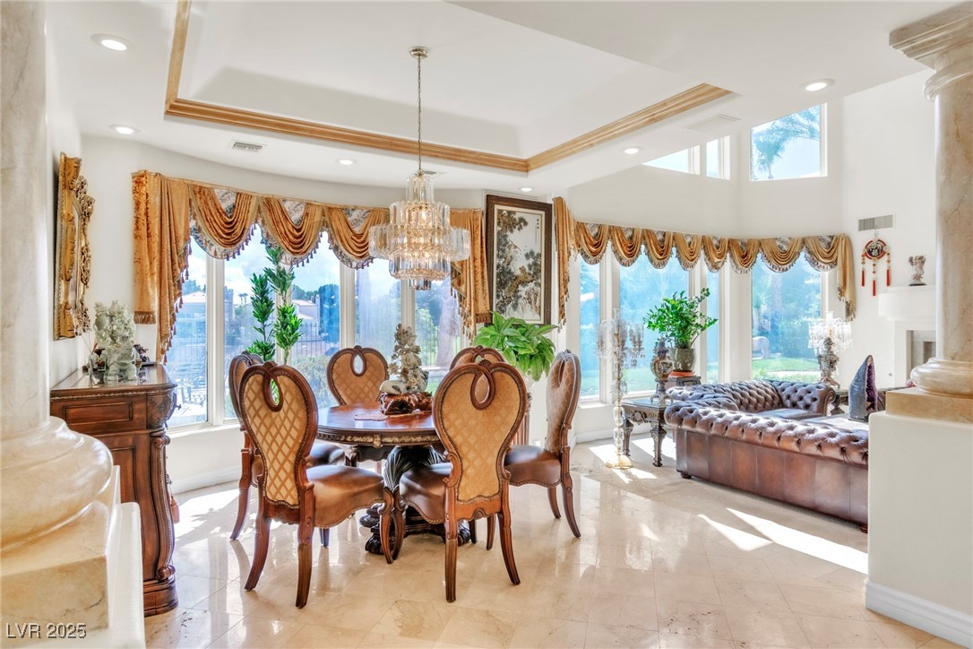 23 Cascade Creek Lane Las Vegas, NV 89113 - Photo 38 of 89 Dining area featuring a chandelier, a tray ceiling, and recessed lighting