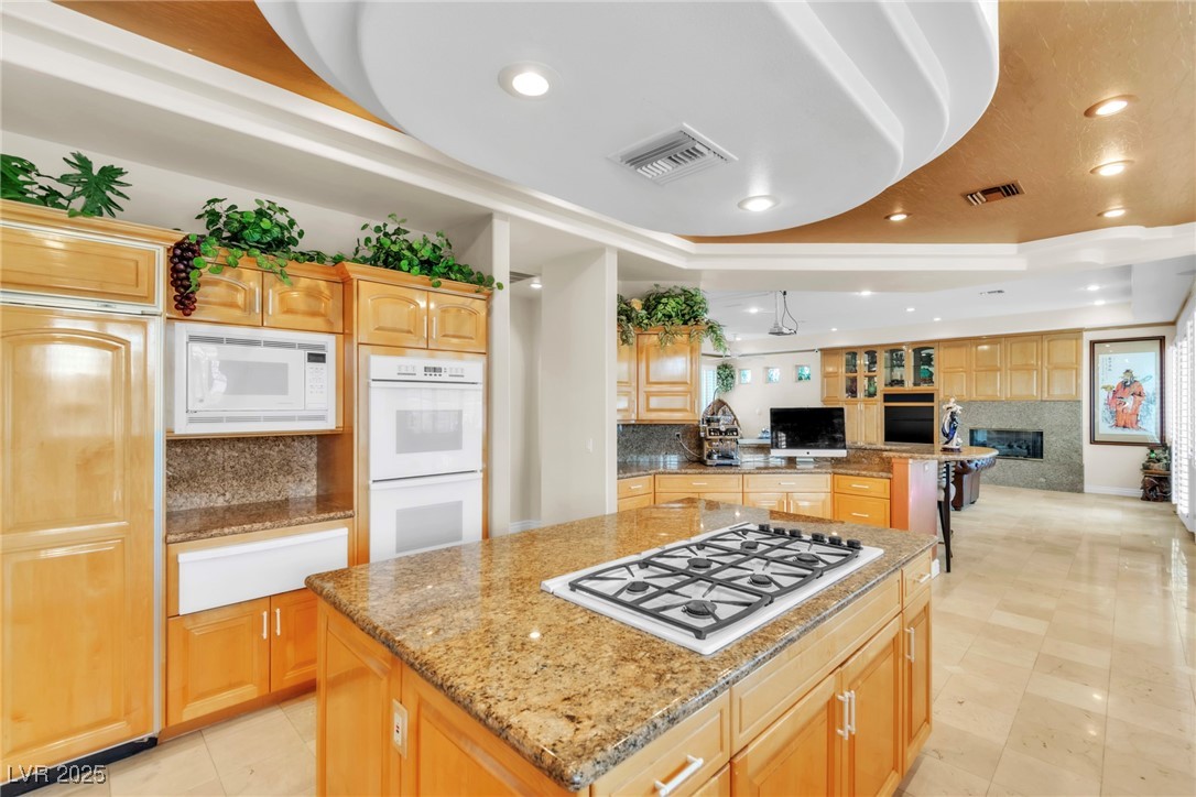 23 Cascade Creek Lane Las Vegas, NV 89113 - Photo 89 of 89 Kitchen with recessed lighting, built in appliances, a center island, light stone counters, and open floor plan
