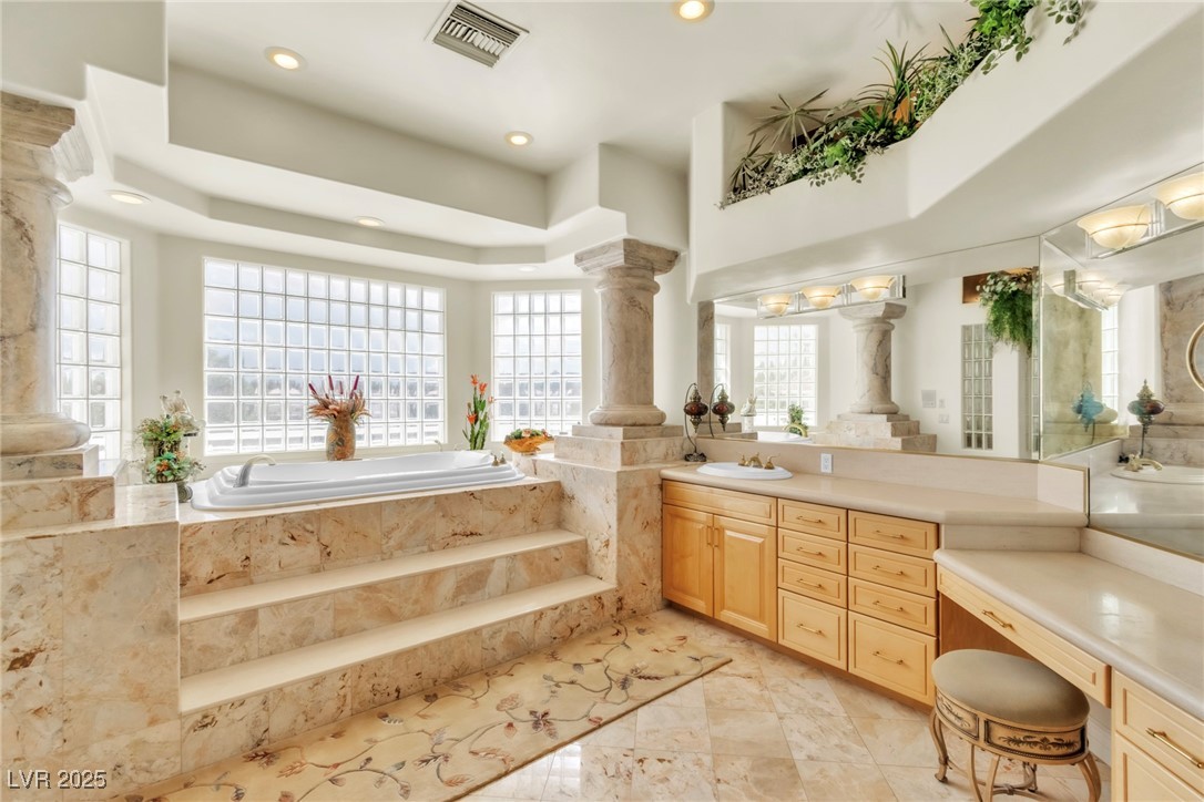 23 Cascade Creek Lane Las Vegas, NV 89113 - Photo 70 of 89 Full bathroom with a bath, vanity, a raised ceiling, and recessed lighting