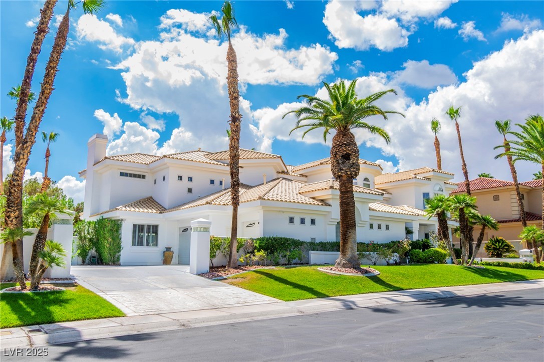23 Cascade Creek Lane Las Vegas, NV 89113 - Photo 8 of 89 Mediterranean / spanish home featuring stucco siding, a chimney, concrete driveway, a tile roof, and a front lawn