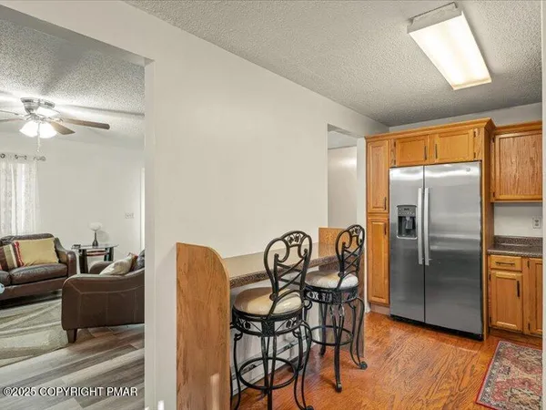 a view of a dining room with furniture a chandelier and wooden floor