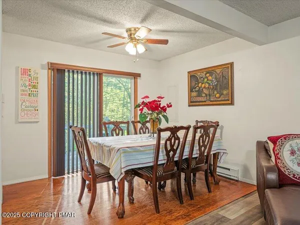 a view of a dining room with furniture window and wooden floor