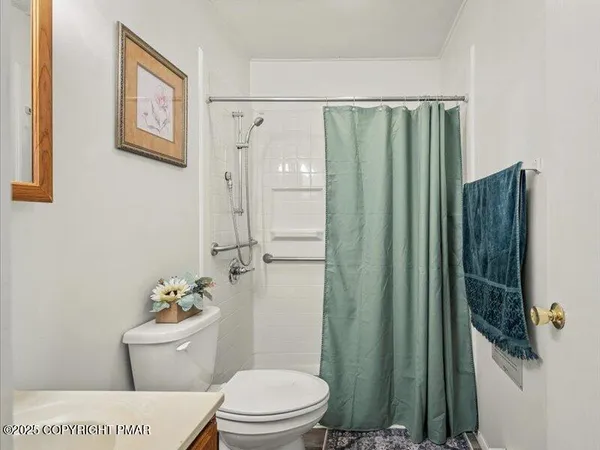 a bathroom with a toilet and a shower