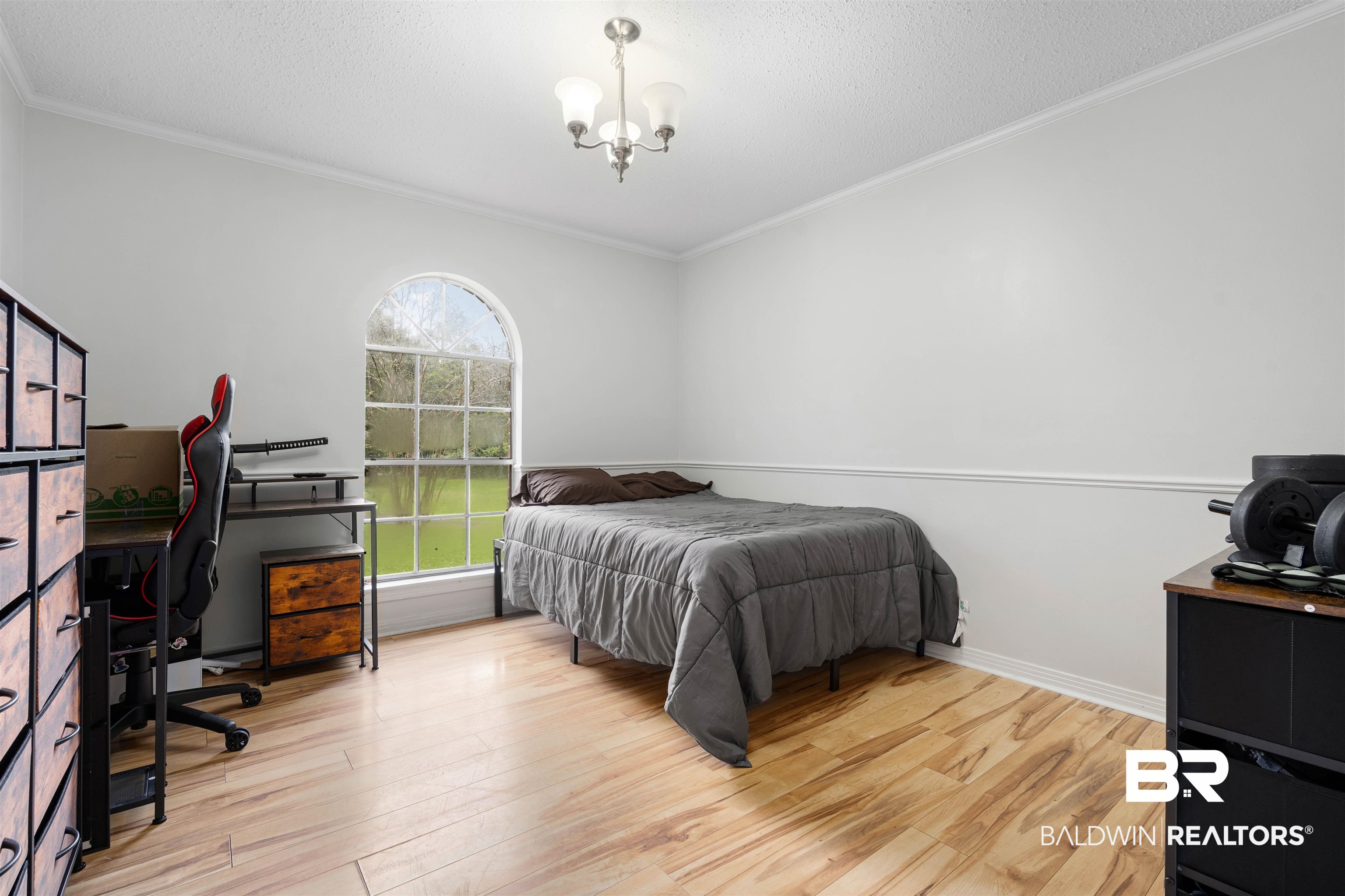 7807 Yorkhaven Road Mobile, AL 36695 - Photo 23 of 34 Bedroom featuring a desk, light wood-style flooring, a textured ceiling, ornamental molding, and a chandelier