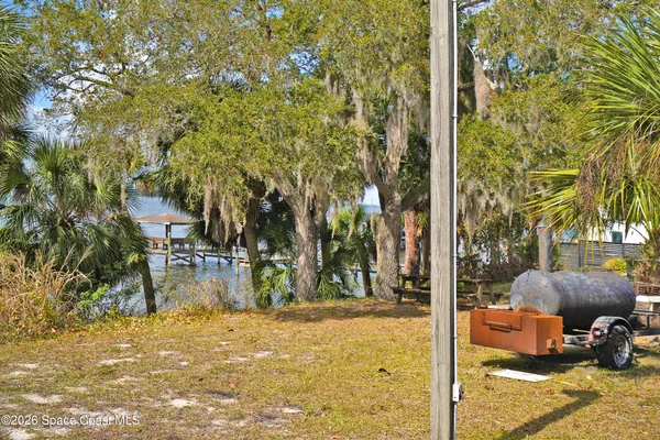 a front view of a house with a garden and patio