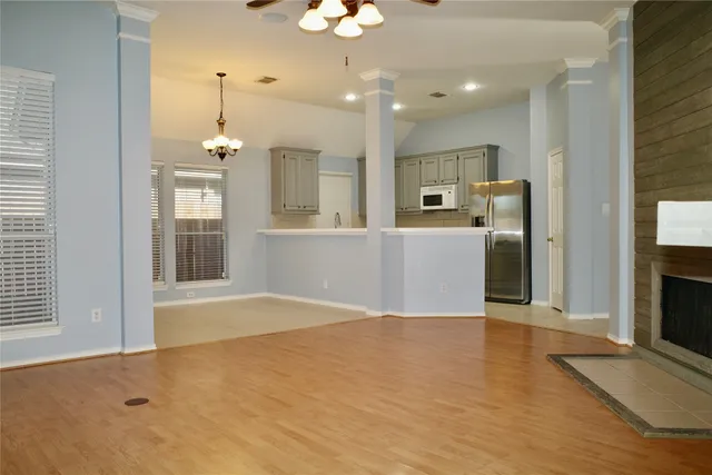 a view of a kitchen with a sink and a refrigerator