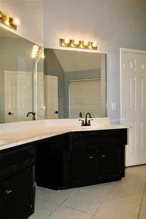 a bathroom with a double vanity sink and mirror
