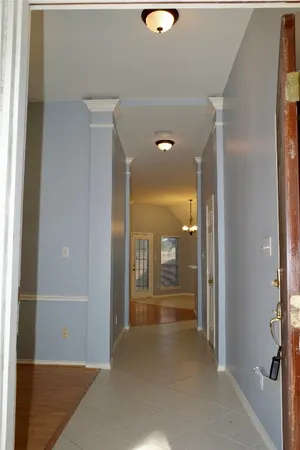 a view of a hallway with wooden shelves