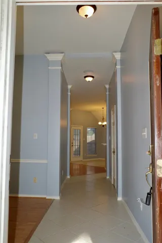 a view of a hallway with wooden shelves