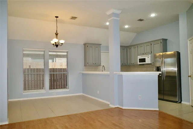 a kitchen with stainless steel appliances granite countertop a refrigerator and a sink