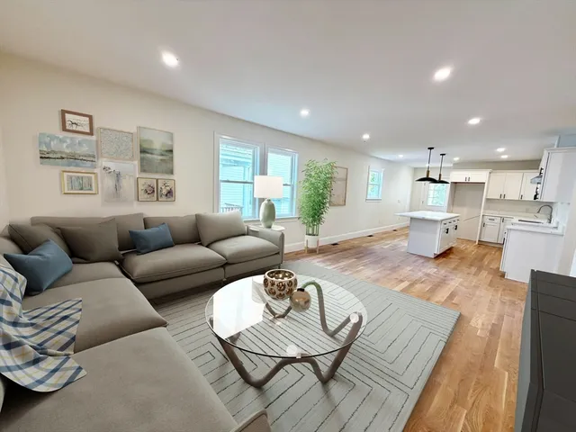 a living room with furniture and kitchen view