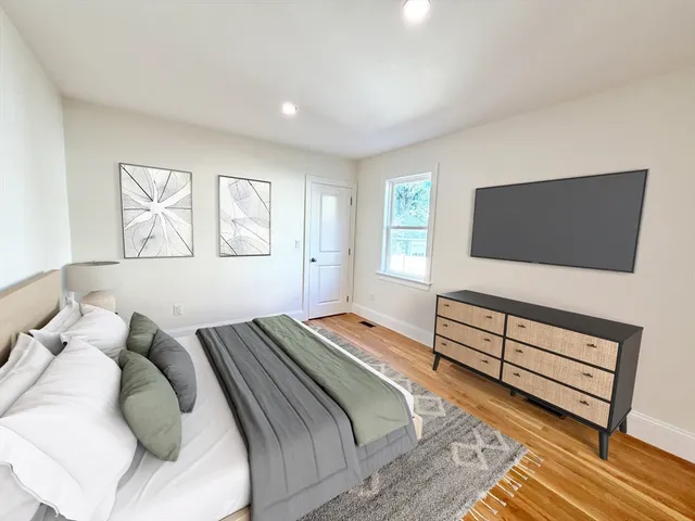 a bedroom with a bed and a flat screen tv