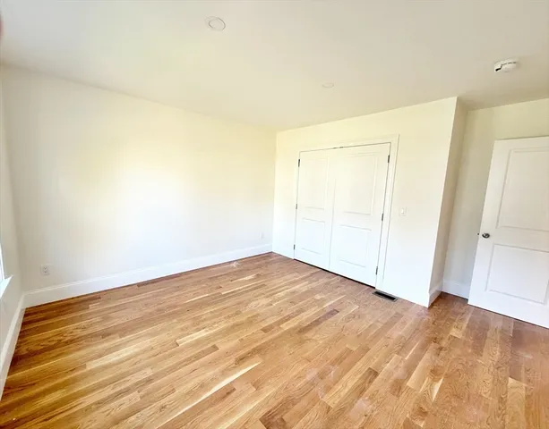an empty room with wooden floor