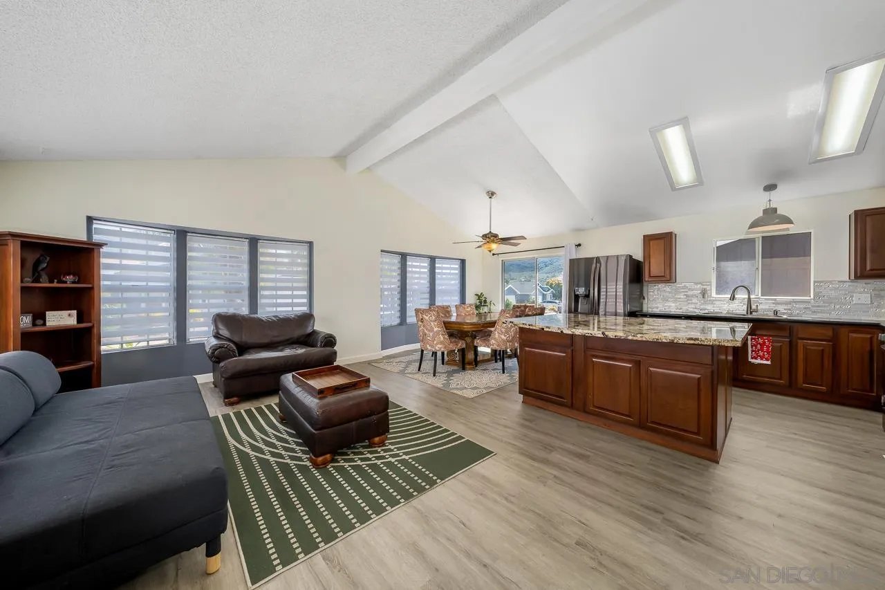 a living room with furniture and kitchen view