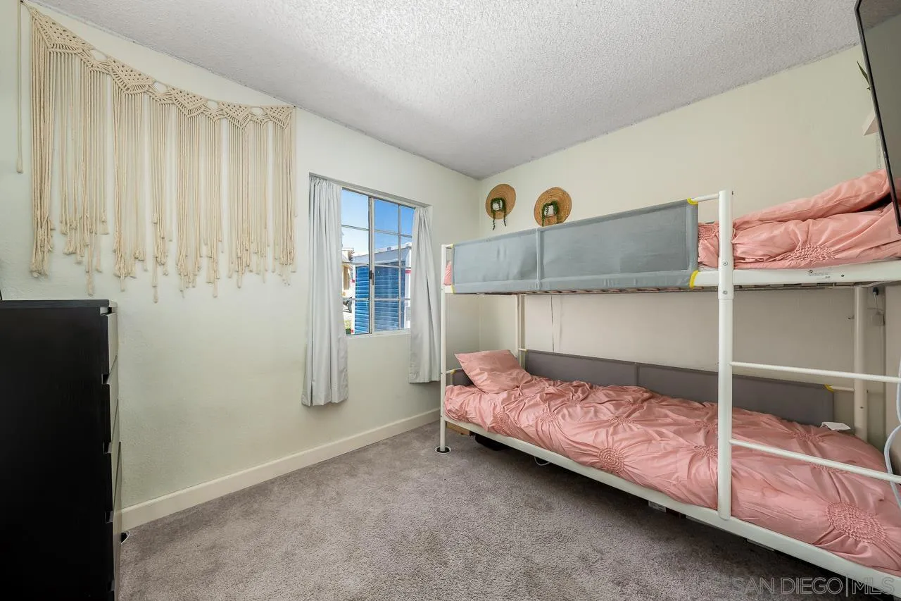 15935 Spring Oaks Road, Unit 201 El Cajon, CA 92021 - Photo 17 of 32 a bedroom with a bed and a window