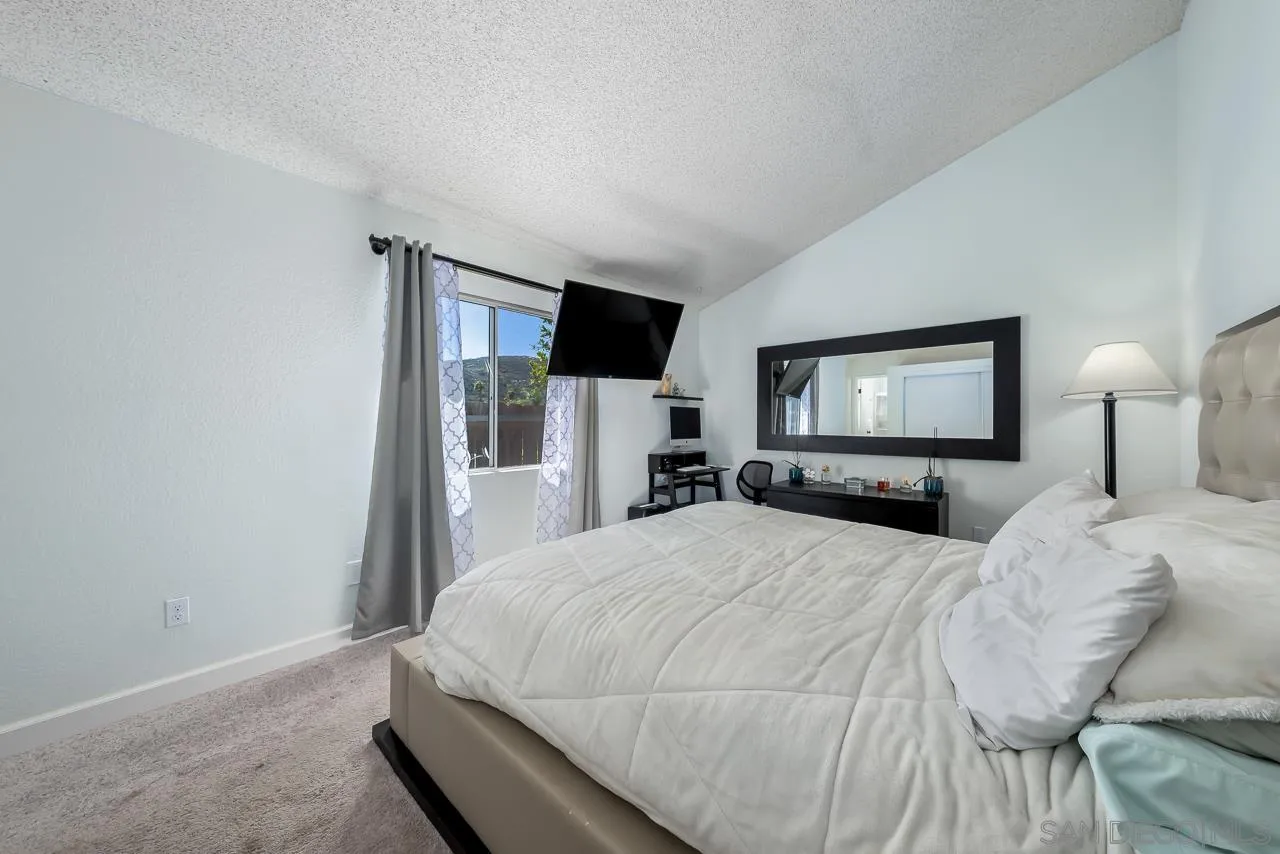 15935 Spring Oaks Road, Unit 201 El Cajon, CA 92021 - Photo 21 of 32 a bedroom with a bed and a tv