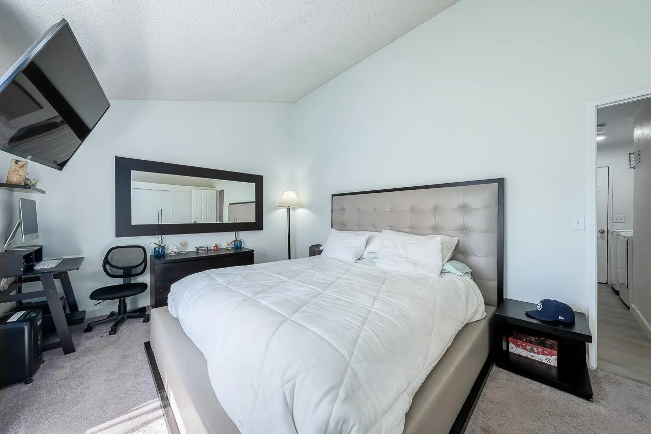 15935 Spring Oaks Road, Unit 201 El Cajon, CA 92021 - Photo 22 of 32 a bedroom with a bed and a flat screen tv