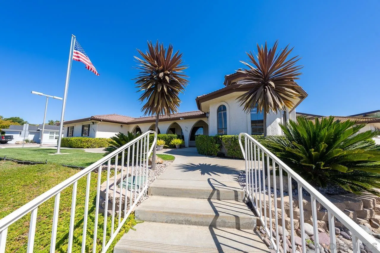 15935 Spring Oaks Road, Unit 201 El Cajon, CA 92021 - Photo 28 of 32 a view of a house with a swimming pool and a chair