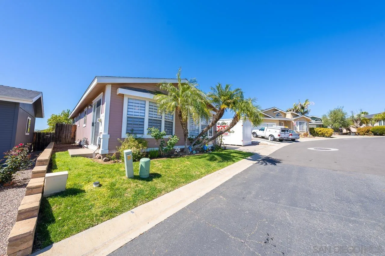 15935 Spring Oaks Road, Unit 201 El Cajon, CA 92021 - Photo 5 of 32 a front view of a house with a yard and trees