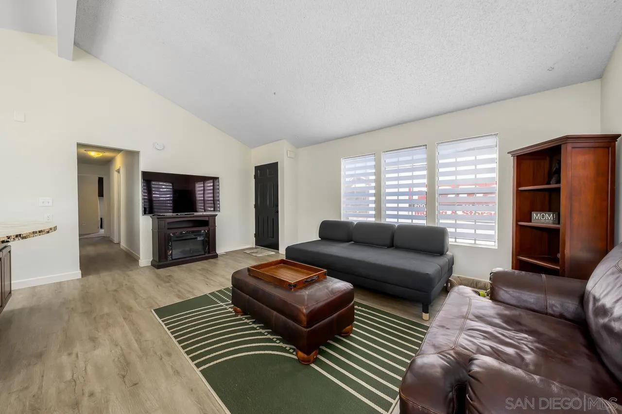 15935 Spring Oaks Road, Unit 201 El Cajon, CA 92021 - Photo 8 of 32 a living room with furniture and a flat screen tv