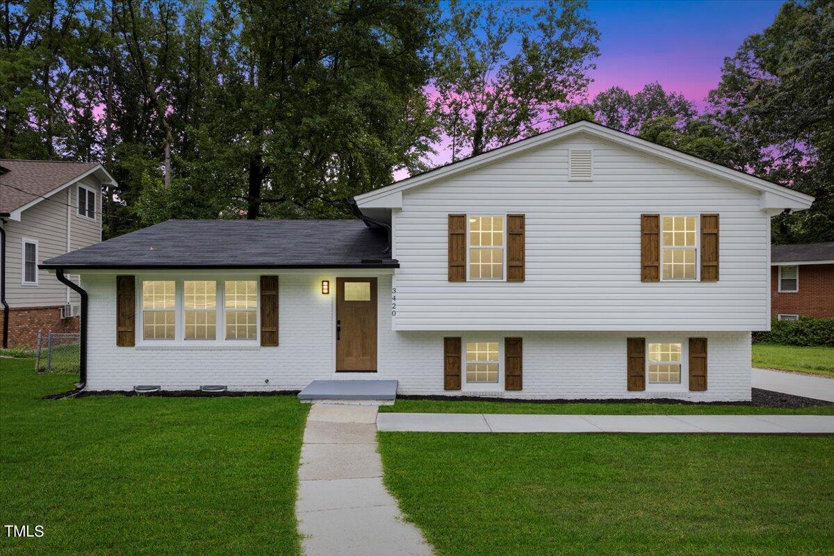 3420 Brentwood Road Raleigh, NC 27604 - Photo 1 of 53 a front view of a house with a garden
