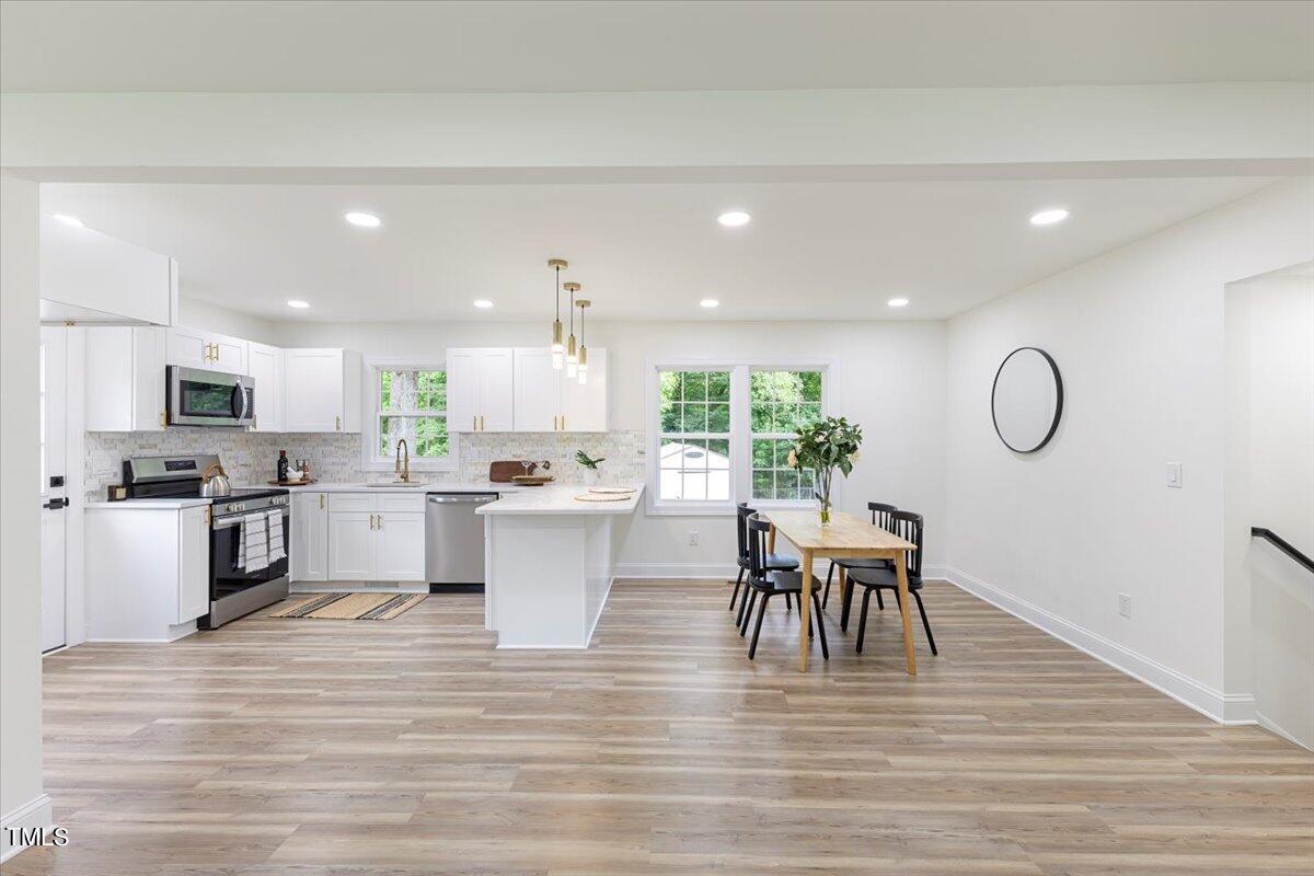 3420 Brentwood Road Raleigh, NC 27604 - Photo 11 of 53 a view of kitchen and dining room with wooden floor