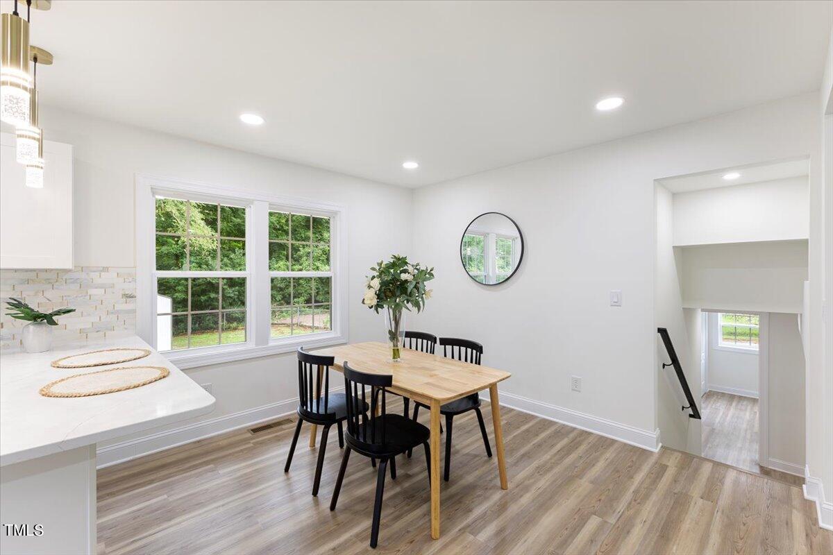 3420 Brentwood Road Raleigh, NC 27604 - Photo 12 of 53 a view of a dining room with furniture window and wooden floor