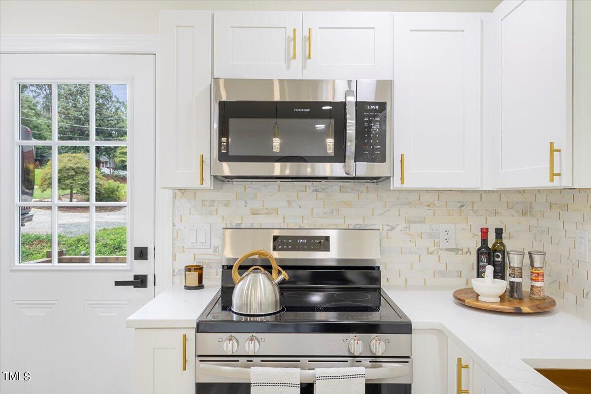 3420 Brentwood Road Raleigh, NC 27604 - Photo 16 of 53 a kitchen with a stove and a microwave