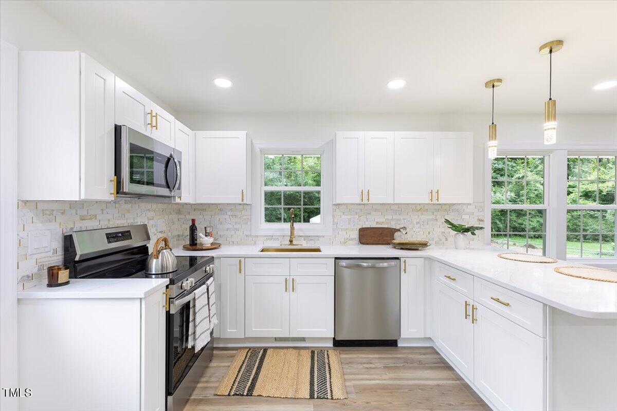 3420 Brentwood Road Raleigh, NC 27604 - Photo 18 of 53 a kitchen with a sink stove and microwave