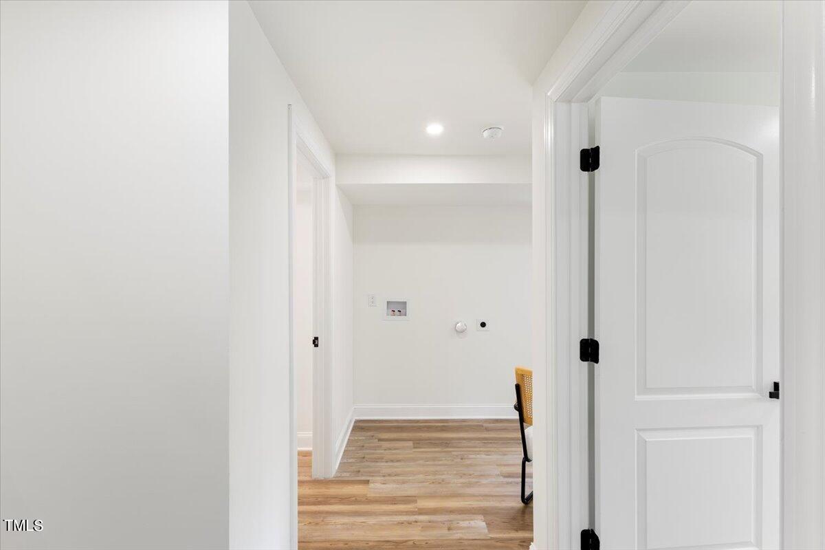 3420 Brentwood Road Raleigh, NC 27604 - Photo 21 of 53 a view of a hallway with wooden floor and staircase
