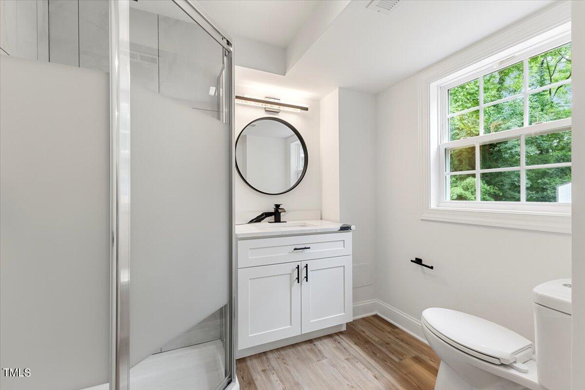 3420 Brentwood Road Raleigh, NC 27604 - Photo 22 of 53 a bathroom with a toilet a sink and a window