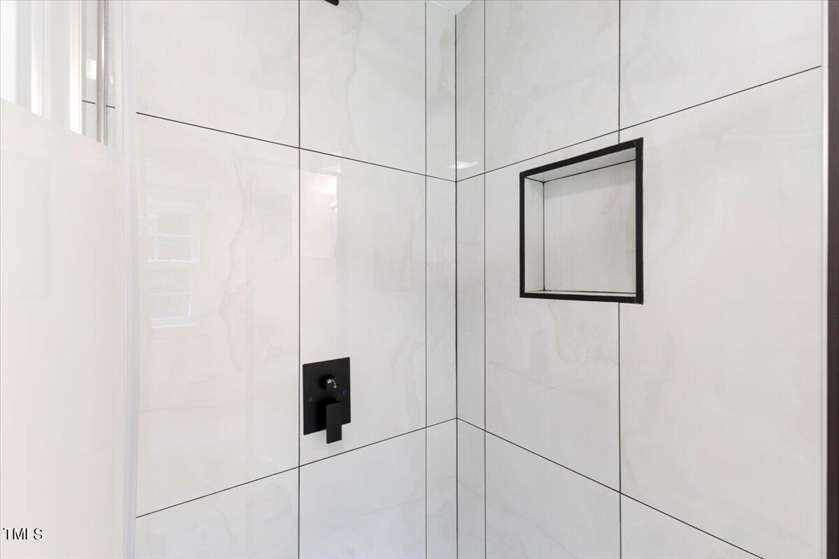 3420 Brentwood Road Raleigh, NC 27604 - Photo 23 of 53 a bathroom with a shower and a mirror